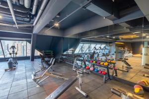 a gym with cardio equipment in a building at Queensland Hotel Bangkok in Bangkok