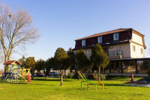 a playground in front of a building with a building at Kapija Grada in Ečka