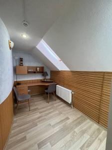 a room with a desk and chairs in a building at Guest House Uzhgorod in Uzhhorod