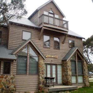 a large house with a balcony on top of it at Square Bear in Dinner Plain