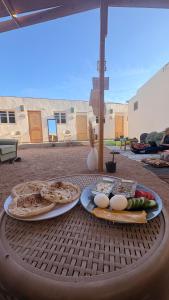 a table with two plates of food on it at SafeZone Guesthouse in Dahab