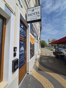 a hotel sign on the side of a building at Sleeping Sailors Boutique Hotel in Siófok