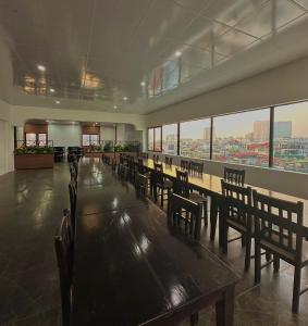 a dining room with a long table and chairs at Sunrise Villa Hanoi in Hanoi +17 photos