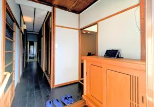 a hallway with a row of shoes in a room at Apt南熱海-網代 in Atami