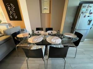 a dining room table with chairs and a refrigerator at Sousse appartement zone touristique in Sousse