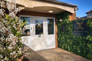 a white front door of a house with flowers at The Briarcroft in Goole
