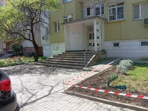 a yellow house with a staircase in front of it at P51 Central - Modern 2 Bedroom Apartment in Stara Zagora