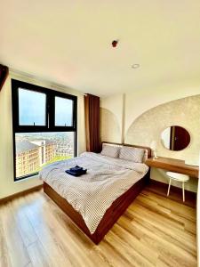 a bedroom with a bed and a desk and a window at Jade's House Sapa - Stunning Views, 3BR, Kitchen & Washer, 5 Min to Town in Lao Cai