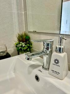 a soap dispenser sitting on a bathroom sink at Jade's House Sapa - Stunning Views, 3BR, Kitchen & Washer, 5 Min to Town in Lao Cai +23 photos