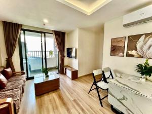 a living room with a couch and a table at Jade's House Sapa - Stunning Views, 3BR, Kitchen & Washer, 5 Min to Town in Lao Cai