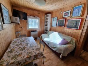 a room with a table and a chair in a room at Bungalow Tirolese in Molina di Ledro