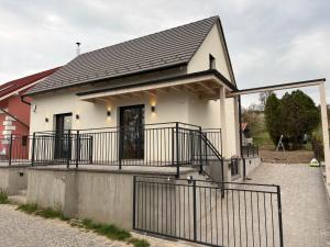 a small white house with a black roof at ZadorHomes Etyek in Etyek