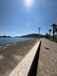 a sidewalk next to a body of water with a street light at Emme9 in Gaeta