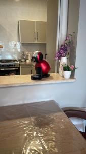 a kitchen counter with a red appliance on a counter top at درة العروس الحالمة in Durat Alarous +12 photos