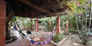 a hammock in a garden with chairs and plants at Villa Guesthouse Bangkok in Bangkok +57 photos