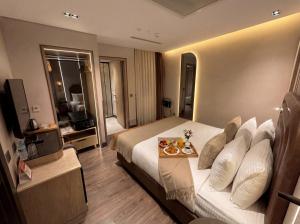 a hotel room with a bed with a tray of fruit on it at Edition Old City Hotel in Istanbul
