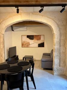 a living room with a table and a couch at VillageStay in Rabat