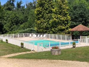 a swimming pool with a fence around it at Le Bief in Pont-et-Massène