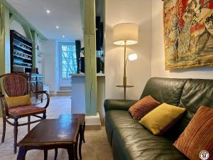 a living room with a couch and a table at Le Bief in Pont-et-Massène