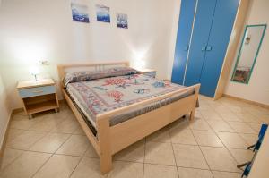 a small bedroom with a bed and a night stand at Appartamento Pina Caletta sul mare con parcheggio privato in La Caletta