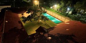 an overhead view of a swimming pool at night at Monsoon Villa in Puttalam +12 photos