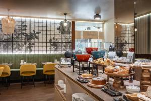 a bakery with a counter with bread and pastries at Hotel Castello in LʼAquila