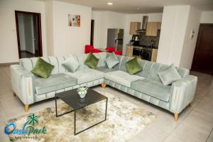 a living room with a couch and a table at OASIS PARK RESIDENCE in East Legon +51 photos