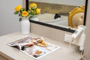 a vanity with a mirror and a plate of food and flowers at Lucky city hotel in Vientiane +106 photos