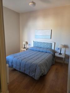a bedroom with a bed and two night stands at CasaManuelaMonesterio in Monesterio