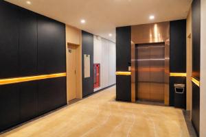 a hallway with black walls and a large elevator at H- Dragon Hotel in Ðố Sơn