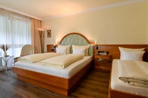 a hotel room with two beds and a window at Hotel Dreiflüssehof in Passau +69 photos
