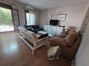 a living room with a couch and two chairs at CasaManuelaMonesterio in Monesterio
