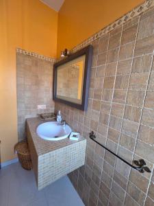 a bathroom with a sink and a mirror at CasaManuelaMonesterio in Monesterio +16 photos