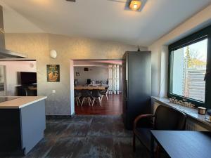 a kitchen and living room with a table and chairs at Cityscape Loft Hannover - 216qm 15 Personen in Hannover