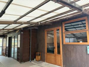 a house being constructed with awning and doors on it at 指宿古民家宿 in Ibusuki