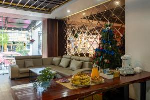 a living room with a christmas tree and a couch at Lucky city hotel in Vientiane