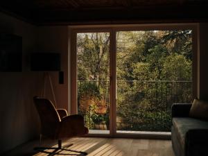 a living room with a sliding glass door at Villa Giacomuzzi in Bolzano +27 photos