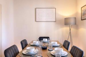 a dining room table with chairs and a tableablish at Laacher-Loft Ferienwohnung in Mendig +11 photos