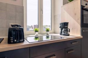 a kitchen counter with a toaster and a coffee maker at Laacher-Loft Ferienwohnung in Mendig