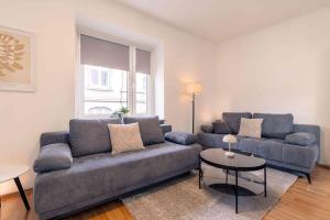 a living room with a couch and a table at Laacher-Loft Ferienwohnung in Mendig