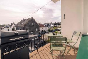 a balcony with a grill and a table and chair on it at Laacher-Loft Ferienwohnung in Mendig