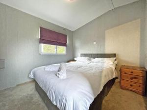 a bedroom with two beds and a window at The Rowan - Uk51410 in Brechin