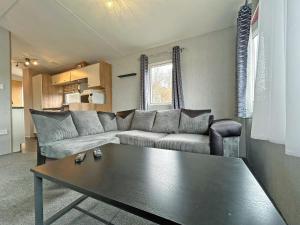 a living room with a couch and a coffee table at The Rowan - Uk51410 in Brechin