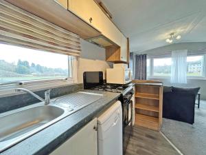an rv kitchen with a sink and a stove at The Rowan - Uk51410 in Brechin +3 photos