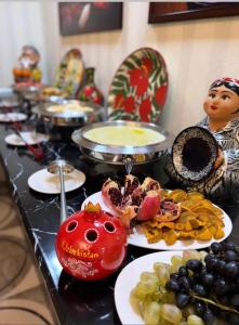 a table with plates of food on a table at Orient Lux in Yakkasaray
