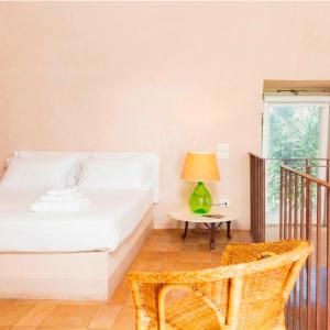 a bedroom with a bed and a table with a lamp at Baia delle Rocce Verdi Resort in Naples