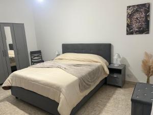 a bedroom with a large bed and a chair at Appartamento in villa in Torre a Mare +6 photos