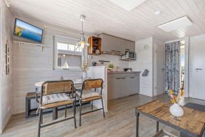 a kitchen and dining room with a table and chairs at Hausboot "Mien Schipp" mit Sonnendeck im Yachthafen in Fehmarn
