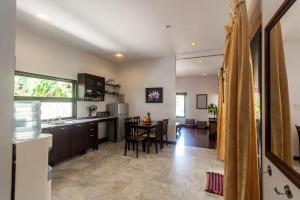 a kitchen and living room with a table and chairs at Southern Lanta A4 in Ko Lanta
