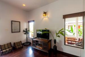 a living room with a tv and a window at Southern Lanta A4 in Ko Lanta